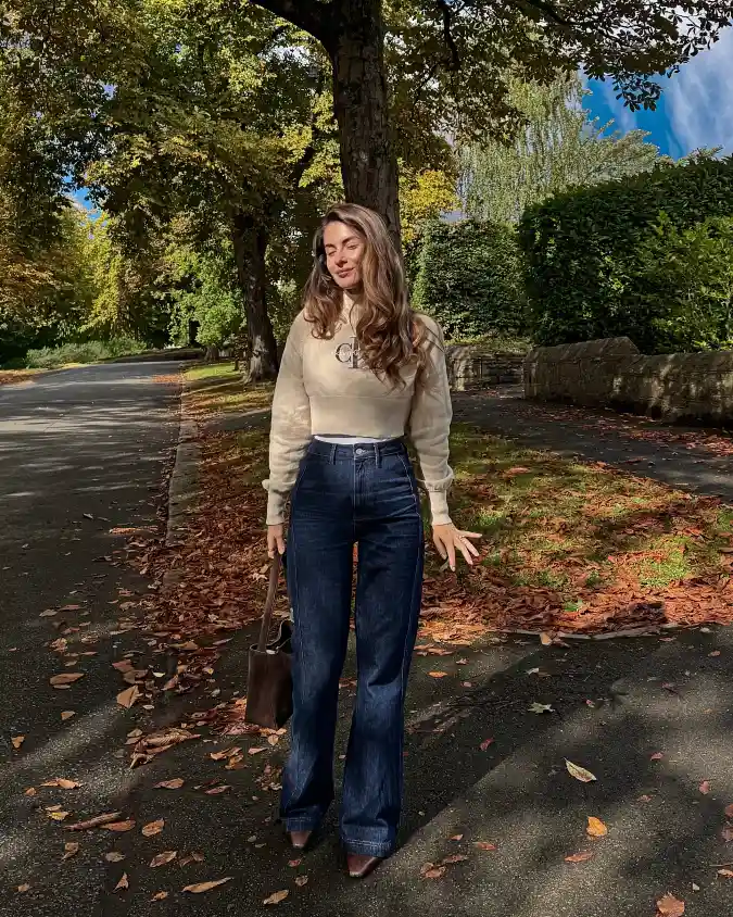 19 Chic outfits for work with jeans That Look Professional 7 The Elevated Knit and Dark Flare Jean Combo